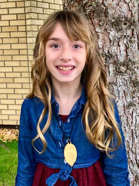 Teenage Girl wearing gold chewelry leaf that looks like real gold jewelry.