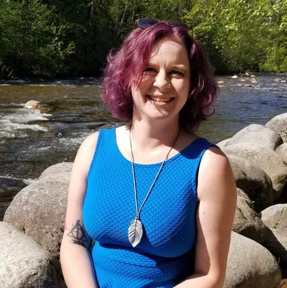 Adult wearing silver leaf chewelry that looks like real jewelry.