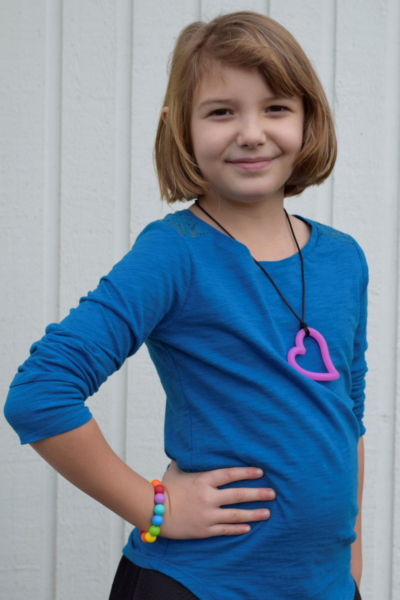 Munchables Heart Chew Necklace worn by a girl.