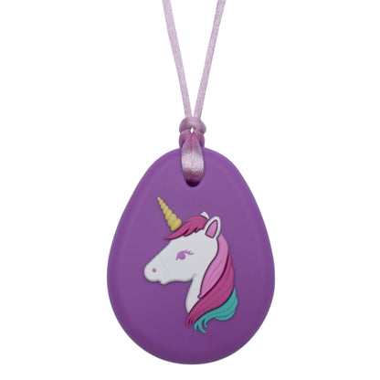 A purple silicone unicorn-shaped chewelry pendant attached to a pink necklace cord.