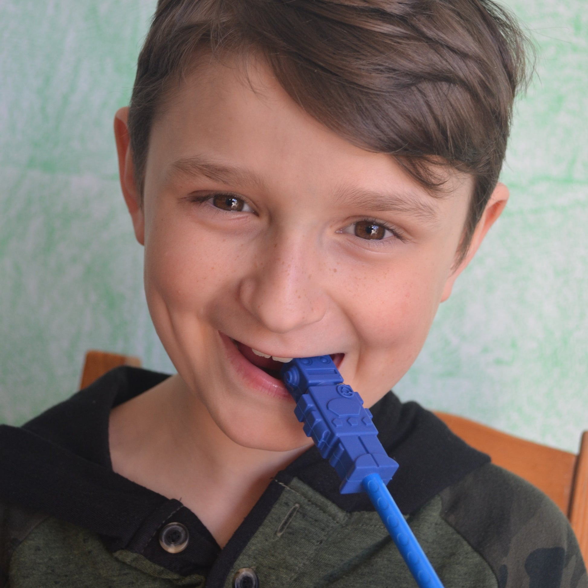 Older child chews on pencil topper.