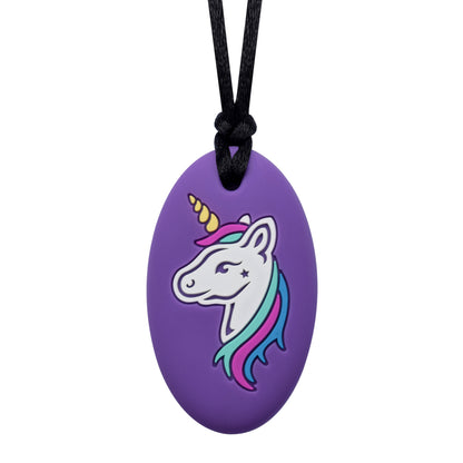 A purple oval-shaped chew necklace with a colorful unicorn design on the front and a textured reverse side.