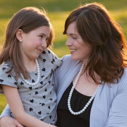 Young girl and mom wear matching Munchables pearl chewelry